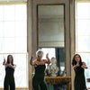 Programme image for "The House of Bernardo Alba". Three women in black stand equally distant from one another. They gesture toward the audience with their hands. 